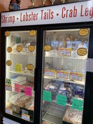 Freezer case of seafood options.  Staff were in the process of restocking shelves