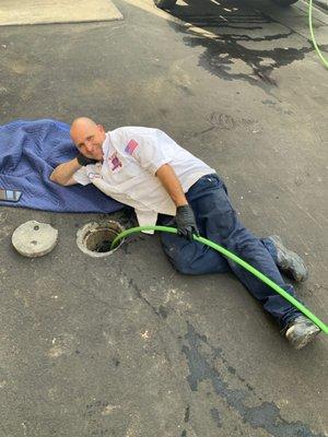 Maintaining light hearted even when things seem tough.  Technician Jason using the hydro jet to clear the way for a local business's drains.