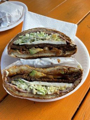 Torta michoacana- has onions, tomatoes, carne milanesa (breaded steak), cheese, lettuce, ham