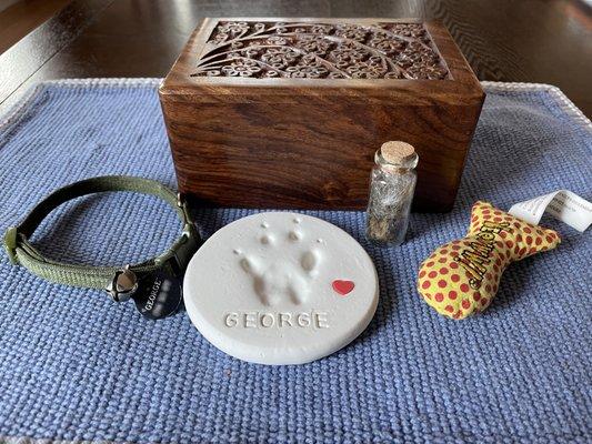 Urn, paw print, and fur clipping