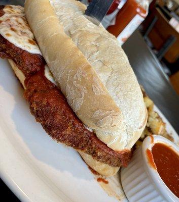 Chicken Parmesan Sandwich with a side of home fries.