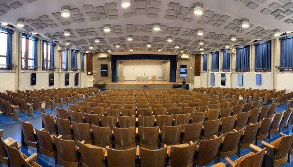 Monitors mounted around the auditorium.