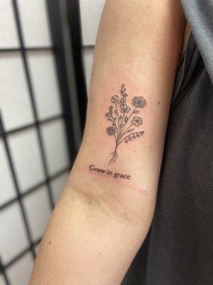 Fine line floral tattoo