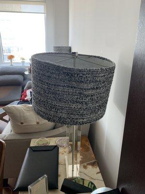 A view of a damaged lamp frame after fabric glued shrunk.