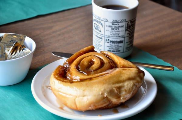 Caramel roll and cup of coffee