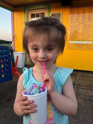 Beautiful Girl eating a Mermaid VooDoo Snowball