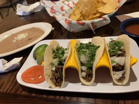 Street tacos with a side of beans.