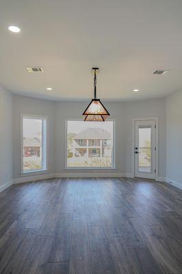 Bright, open space featuring natural light, modern flooring, and a statement pendant light -- the perfect blank canvas for any home design.