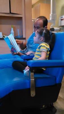 Reading a story and getting my daughter ready to get her teeth cleaned.  How many dental places do you know, that does this?