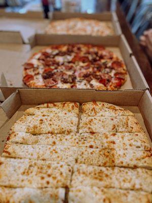 Cheese breadsticks, pepperoni pizza and chicken Alfredo pizza