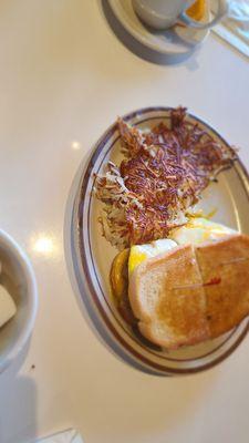 Breakfast sandwich with sunny side up egg and hash brown with bacon