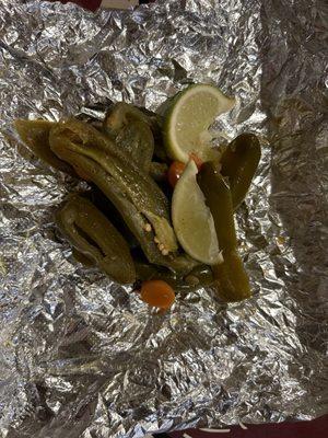 Pickled Jalapeños with Pickled carrots and limes.  With every order.