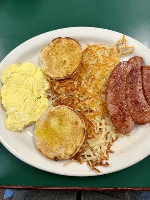 Scrambled eggs, reindeer sausage, hash browns, and English muffin.