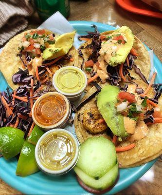 Shrimp tacos are served on flour tortilla but corn is tastier!