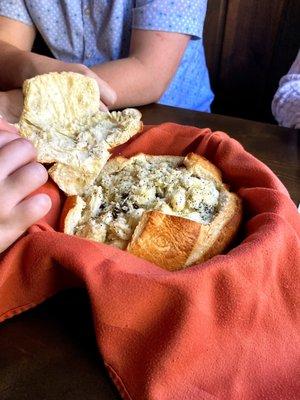 Rastons (bread bowl filled with seasoned bread pieces with dried fruit, fennel, and seasonings)