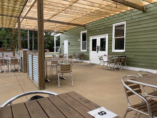 Spacious outdoor seating with pergola shading.