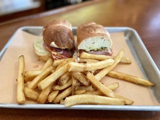 "Muffuletta Sandwich" (ham, salami, prosciutto, capicola, provolone, olive tapenade on toasted brewer's bread) with Fries