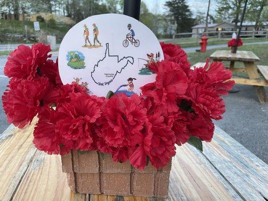 Colorful tabletop decorations saluting 'National Travel & Tourism Week.' Love the picnic table area! Clean and inviting!