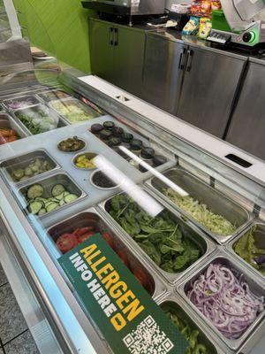 Clean, quality, organized display of veggies for my sandwich.  Appealing.