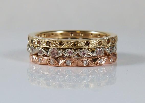 Hand carved tri-colored gold stacking set with natural pink, cognac, chocolate, yellow and white diamonds.