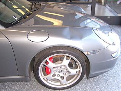 Softball size dent in a brand new Porsche.