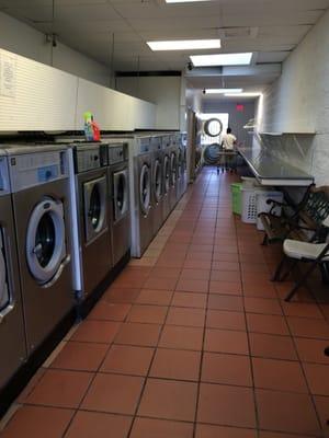 C & C Coin Laundry: second side of washers, dryers, & folding table ranging from $3, $3.50, $4, $6, $7.50