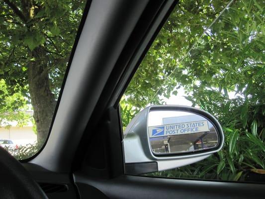 Nice shady spot in front of the post office!  (photo flipped horizontally so you can read the sign)