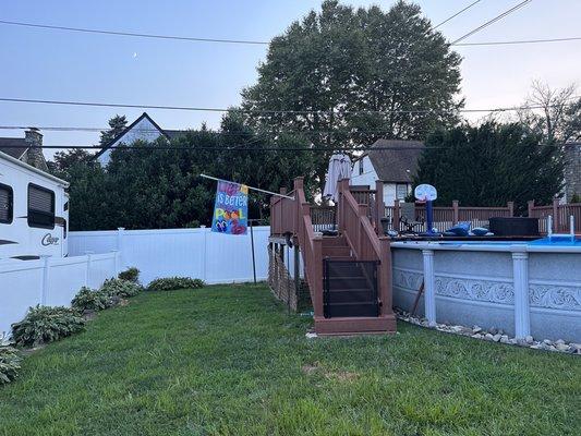 Another view of the back fence compared to the rail of the deck.