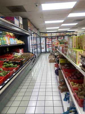 Produce front, refrigerated/frozen foods rear.