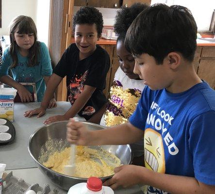 School-age care making an edible creation.