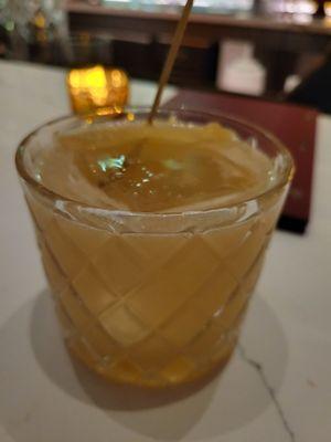 Western medicine: bourbon, lemon juice,  ginger honey syrup, and mezcal float