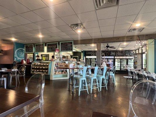 Indoor seating with a few tables outside.