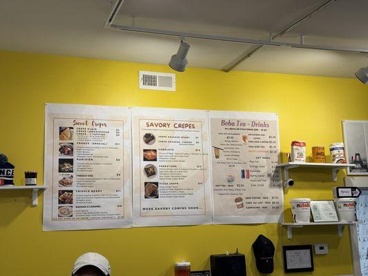 Prices are clearly displayed in a small, immaculate eating area with  cheerful yellow accent wall.