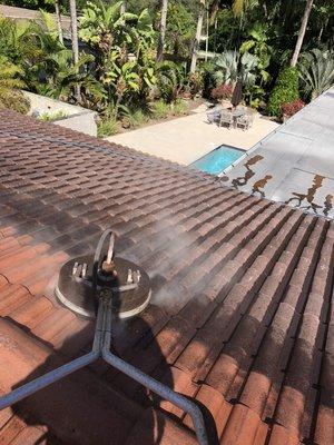 Pressure washing a roof and fixing broken roof tiles