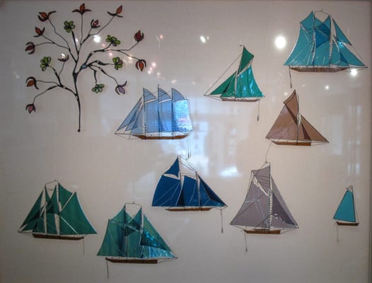 Glass sailboats, replicas of actual famous ships (like Mayflower)