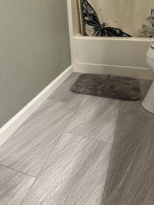 New waterproof plank flooring replacing old laminate in bathroom.