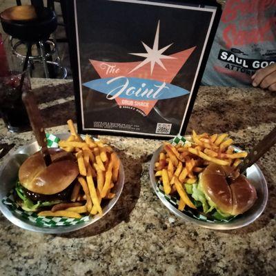 The burger  on the left is the Hawaii 5-0  grilled pineapple slice two qtr pound patties .sweet habanero spread lettuce and cheese.