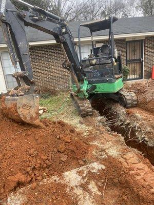 Digging up a sewage line that was blocked by roots