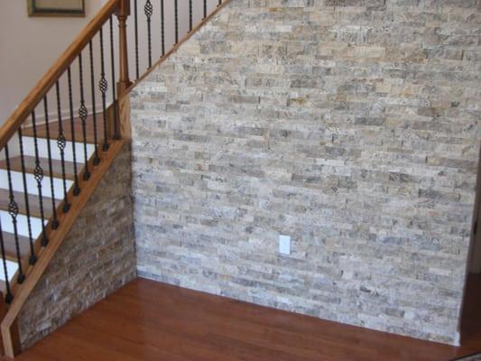 Hardwood, custom staircase, and quartz ledgestone