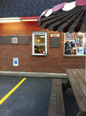 Side walk up window with picnic benches.