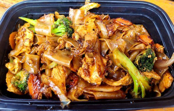 Pad See Ew; wide noodle, egg, onion, carrot, broccoli and chicken.