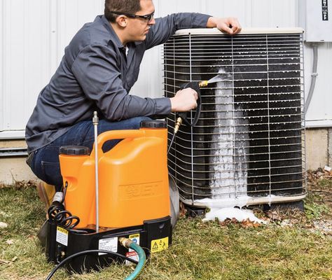 Outdoor condenser being cleaned of years of gunk.