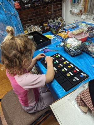 Putting together the selected beads for the bracelet.