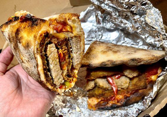 Pizza sandwich-breaded eggplant,meatballs,onions,bell peppers,tomato chunks & cheese in fresh baked, crispy personal pizza crust - awesome!