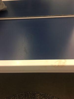 Blood in the shape of a persons bottom on the blue and smeared down the front of the bench on the white part.