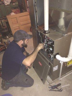 Technician starting up a new Bryant furnace after installation