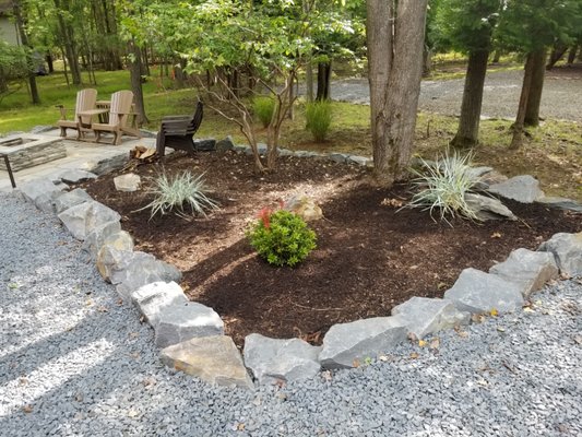 Bluestone garden edging with natural mulch. Some fresh plantings