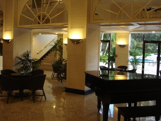 PALM BAY YACHR CLUB CONDO LOBBY WITH A BLACK BABY GRAND PIANO