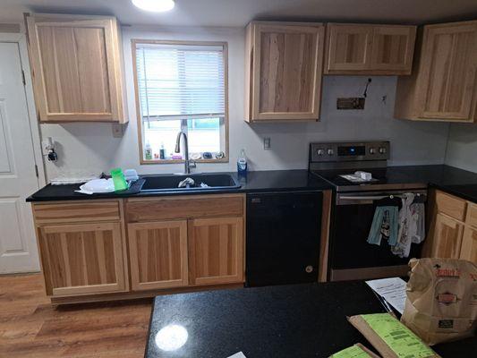 Backsplash was never done and the sink wasn't secured. Cabinets hung unevenly. Many incomplete tasks