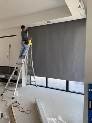 Motorized shades installation at a residential construction site